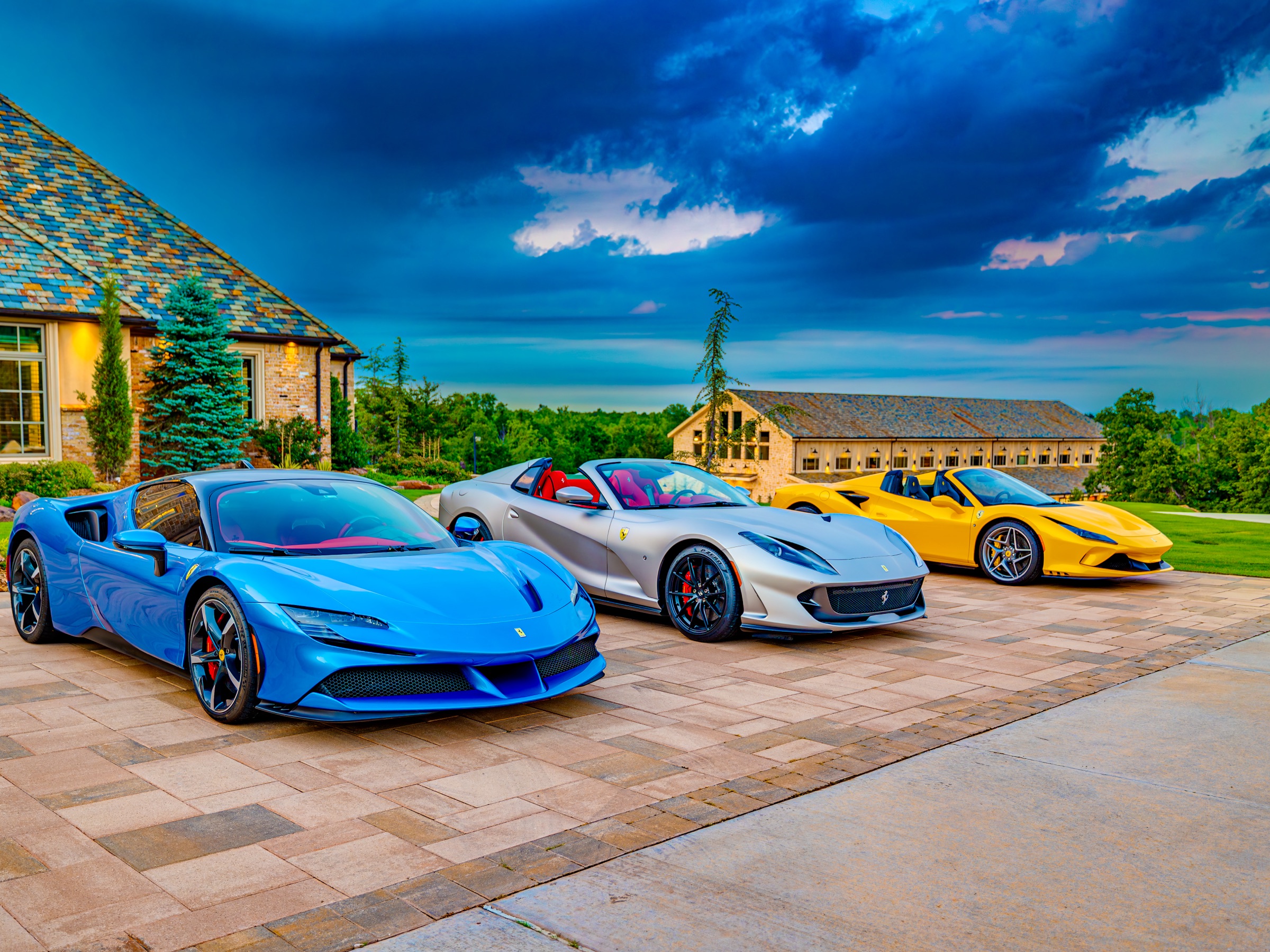 Three Ferraris at golden hour in front of 36 Acres estate
