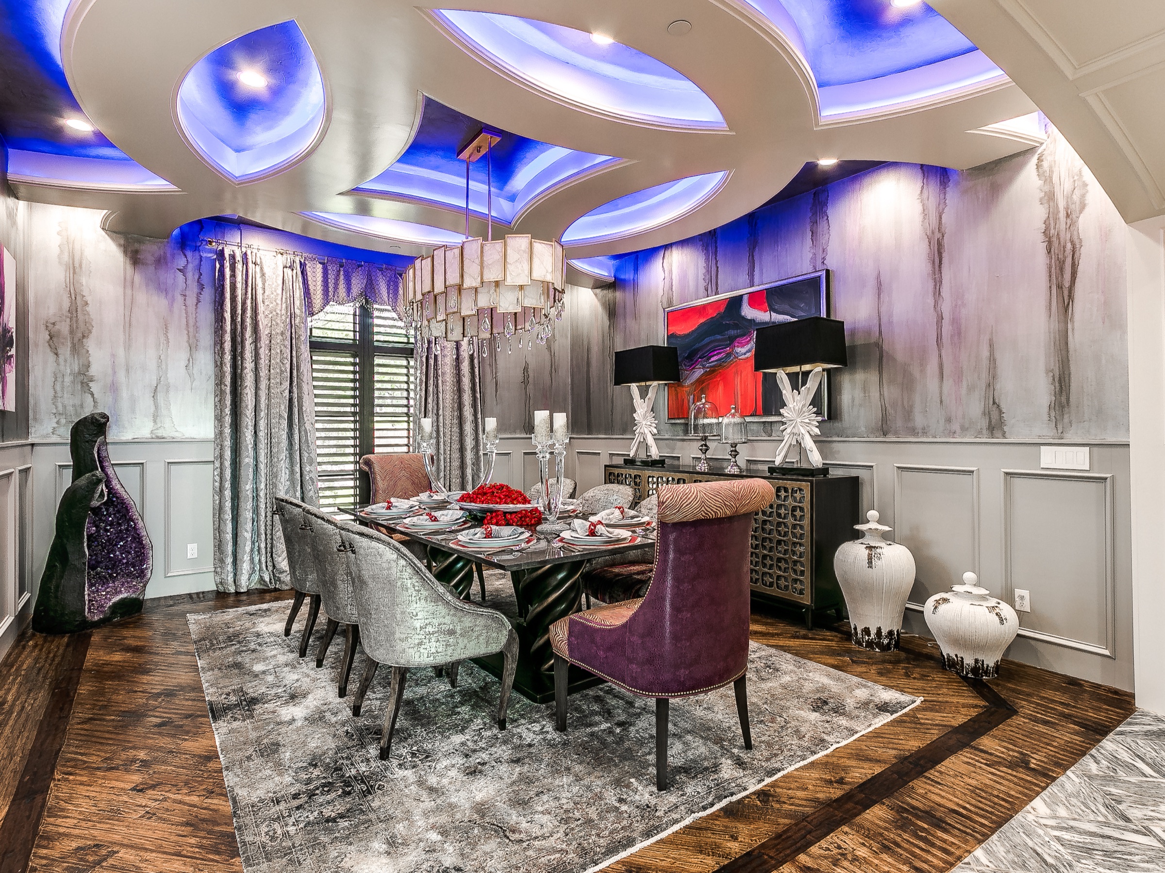 Dramatic luxury dining room with blue LED ceiling