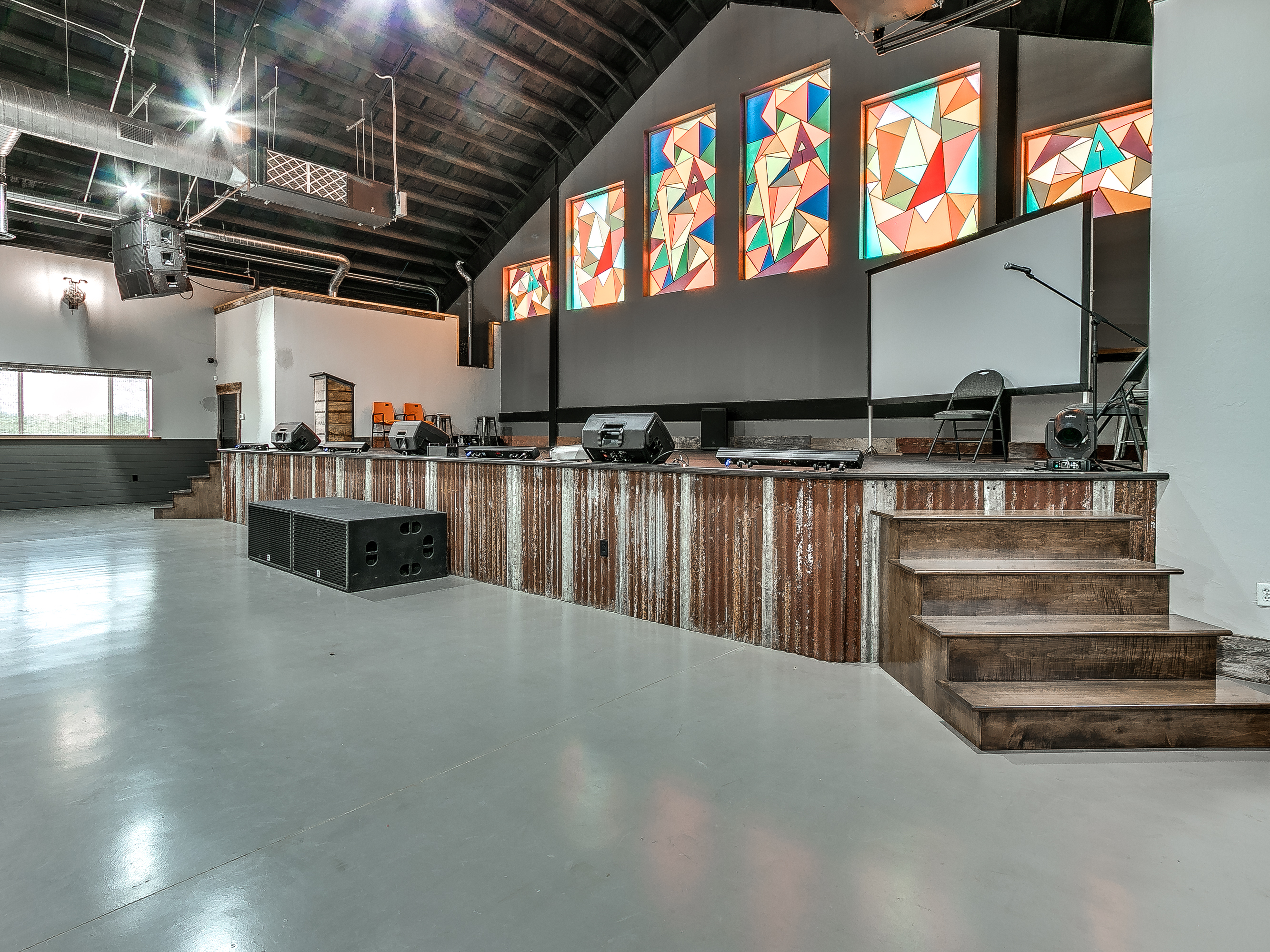 The Barn — interior with performance stage and stained glass