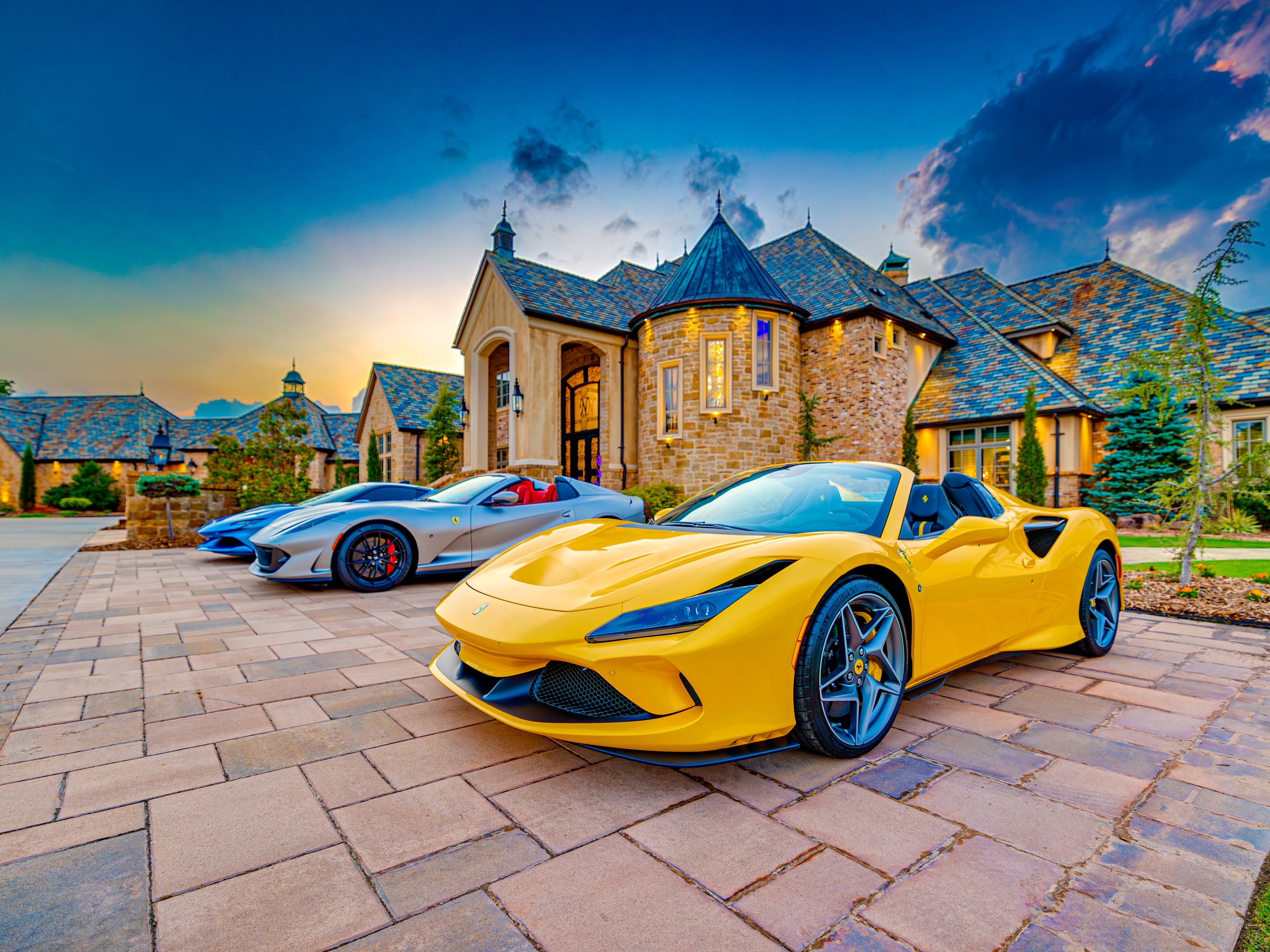 Yellow Ferrari at golden hour outside the main house
