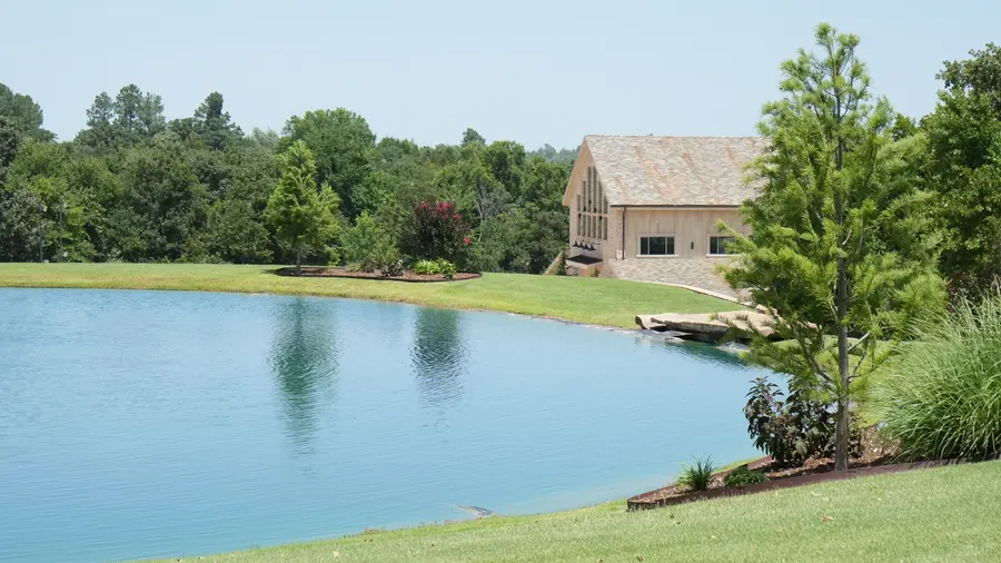 The grounds at 36 Acres, the pond with the hall beyond it