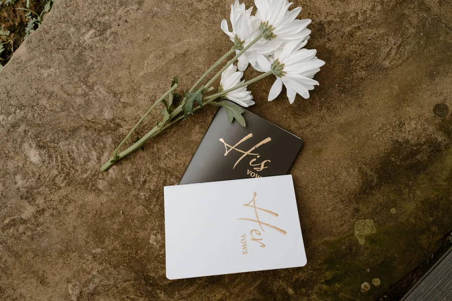 Vow books and a small bouquet at 36 Acres